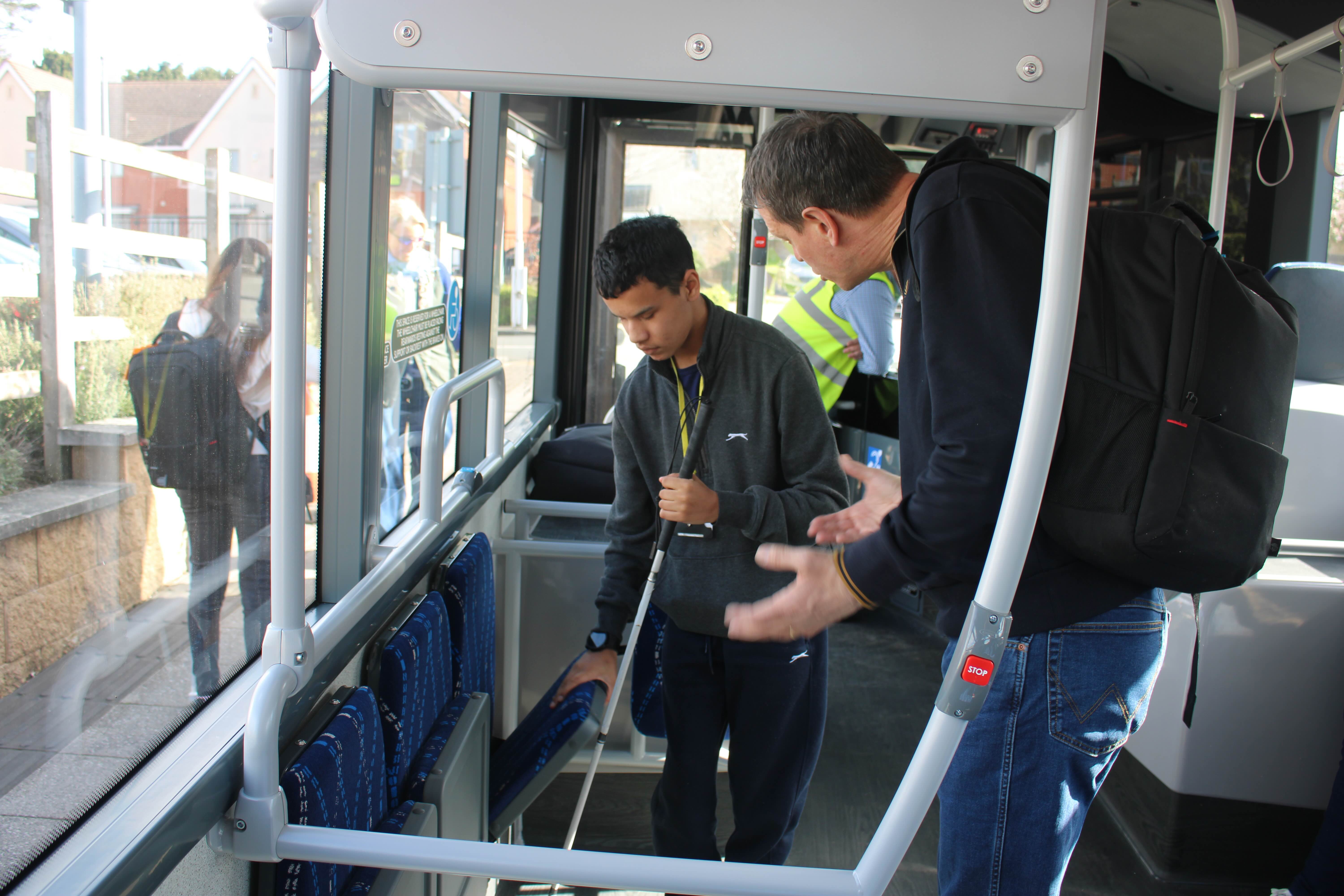 Zayed and Rich trying out the foldaway seats on the bus
