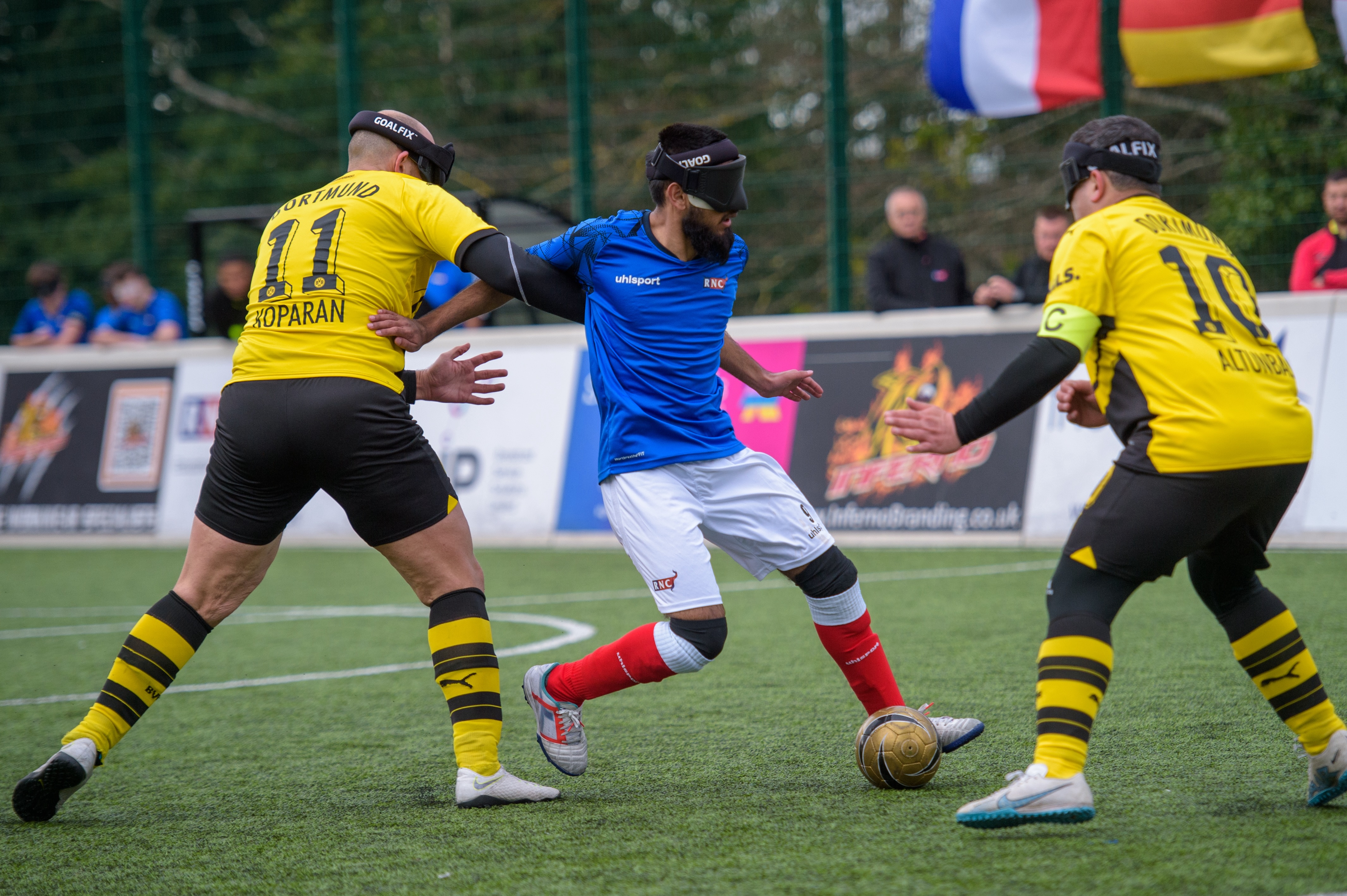 An RNC player weaving his way through two Dortmund players