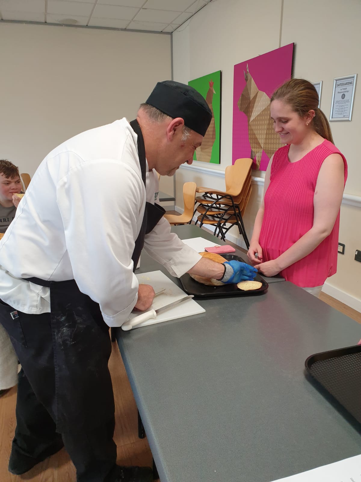 Cutting a slice of one of the loaves