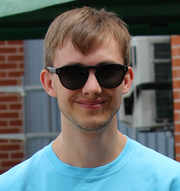 A headshot of Tom smiling