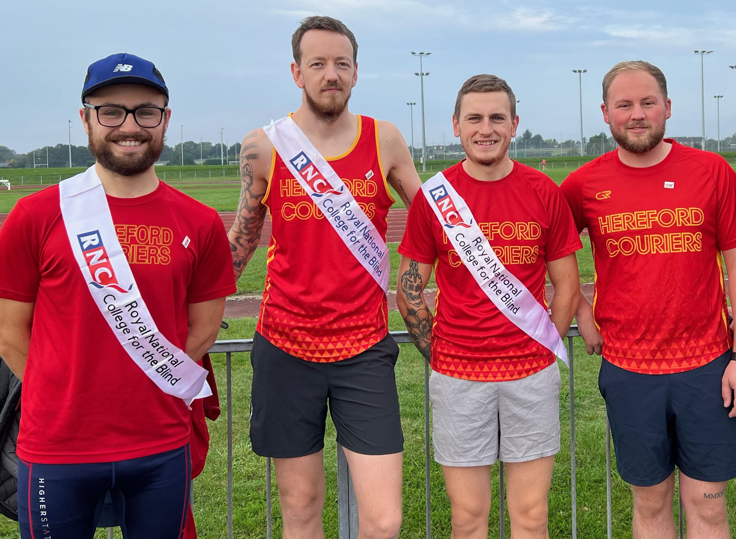 four of the runners standing in a row wearing their Hereford Courier t-shirts