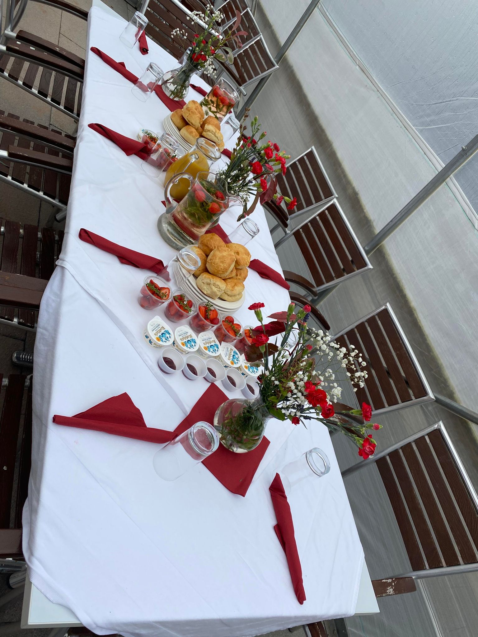 Table set up with tablecloth, serviettes, flowers and the cream tea