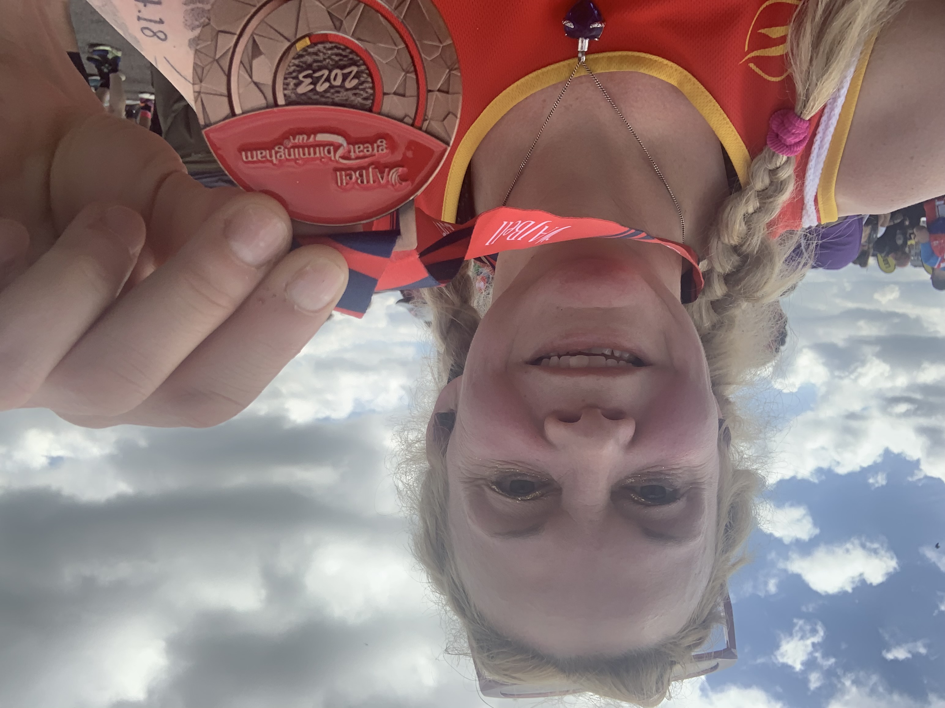 Freya at the end of a race holding up a medal