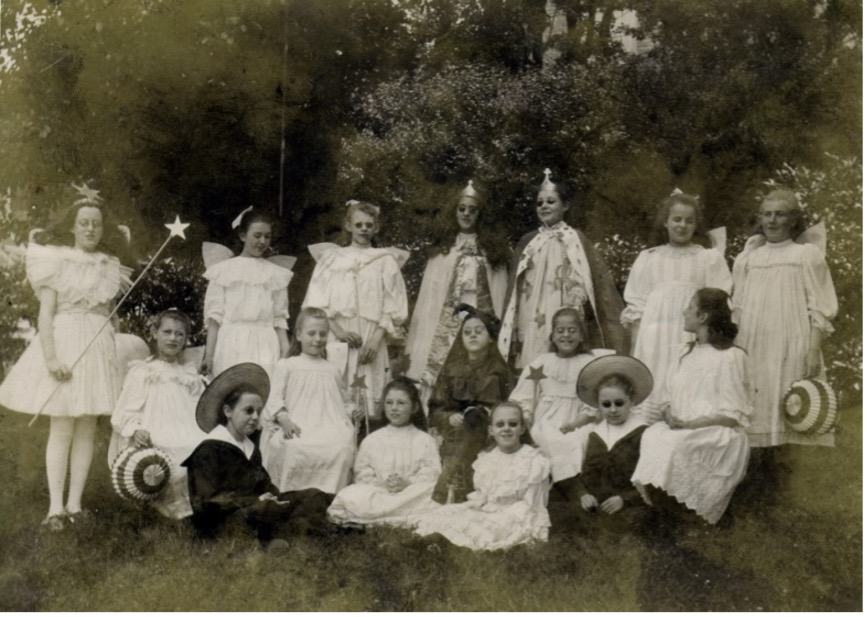 a group of 16 girls in theatre costumes 