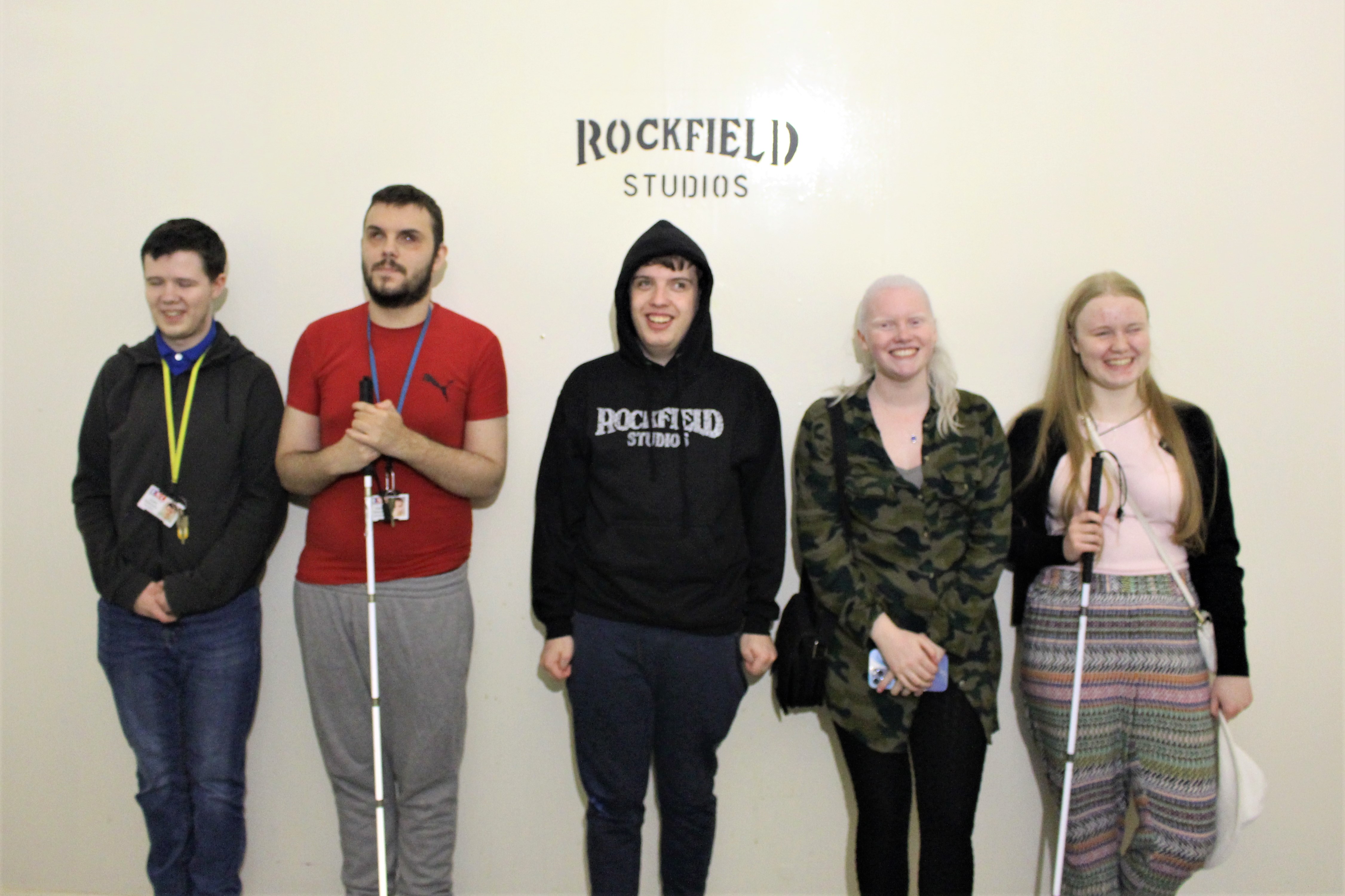a group of 5 students stand in one of the echo chambers under a Rockfield Studios sign 
