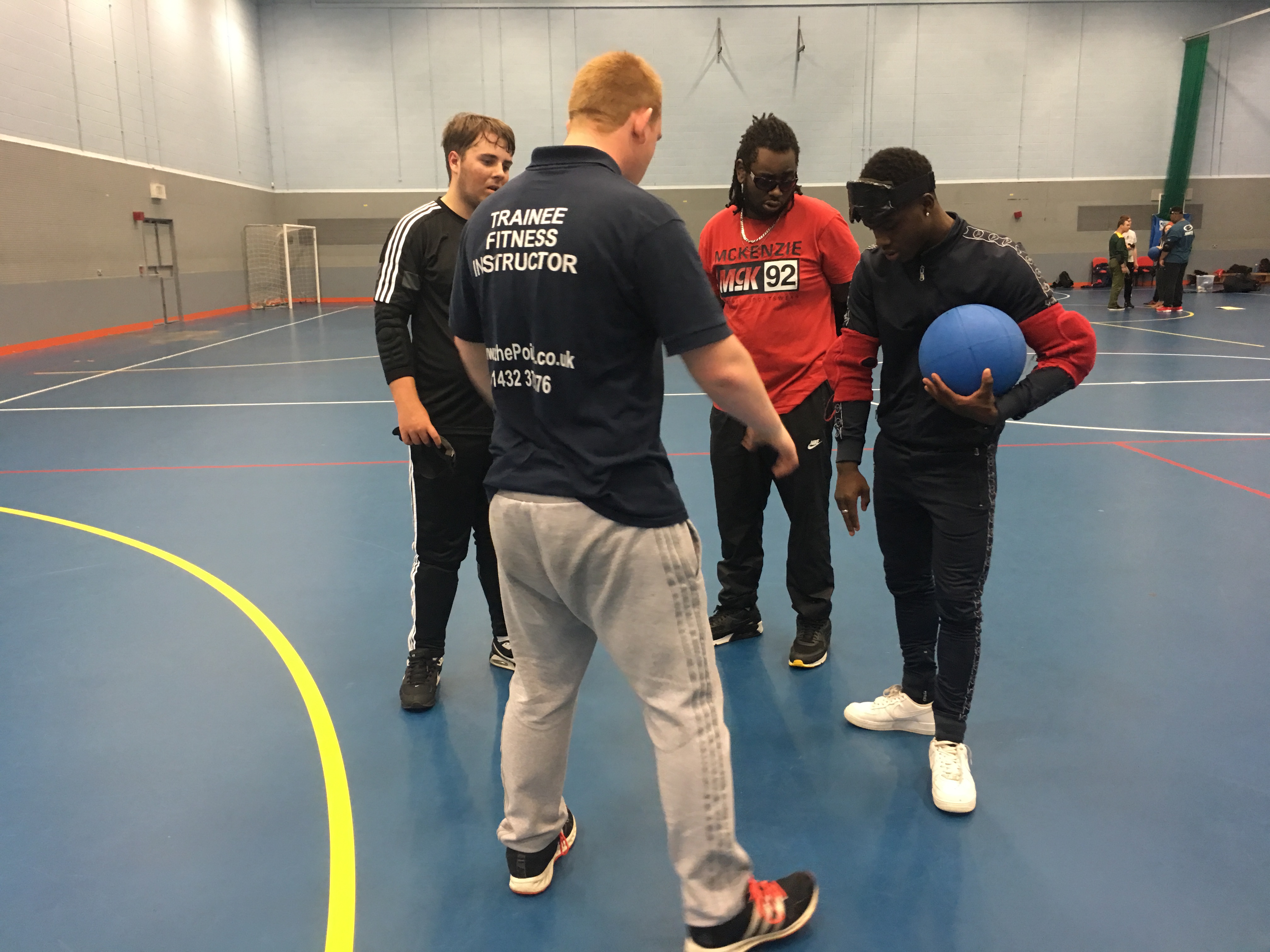a male student instructor delivers a coaching session to 3 male students