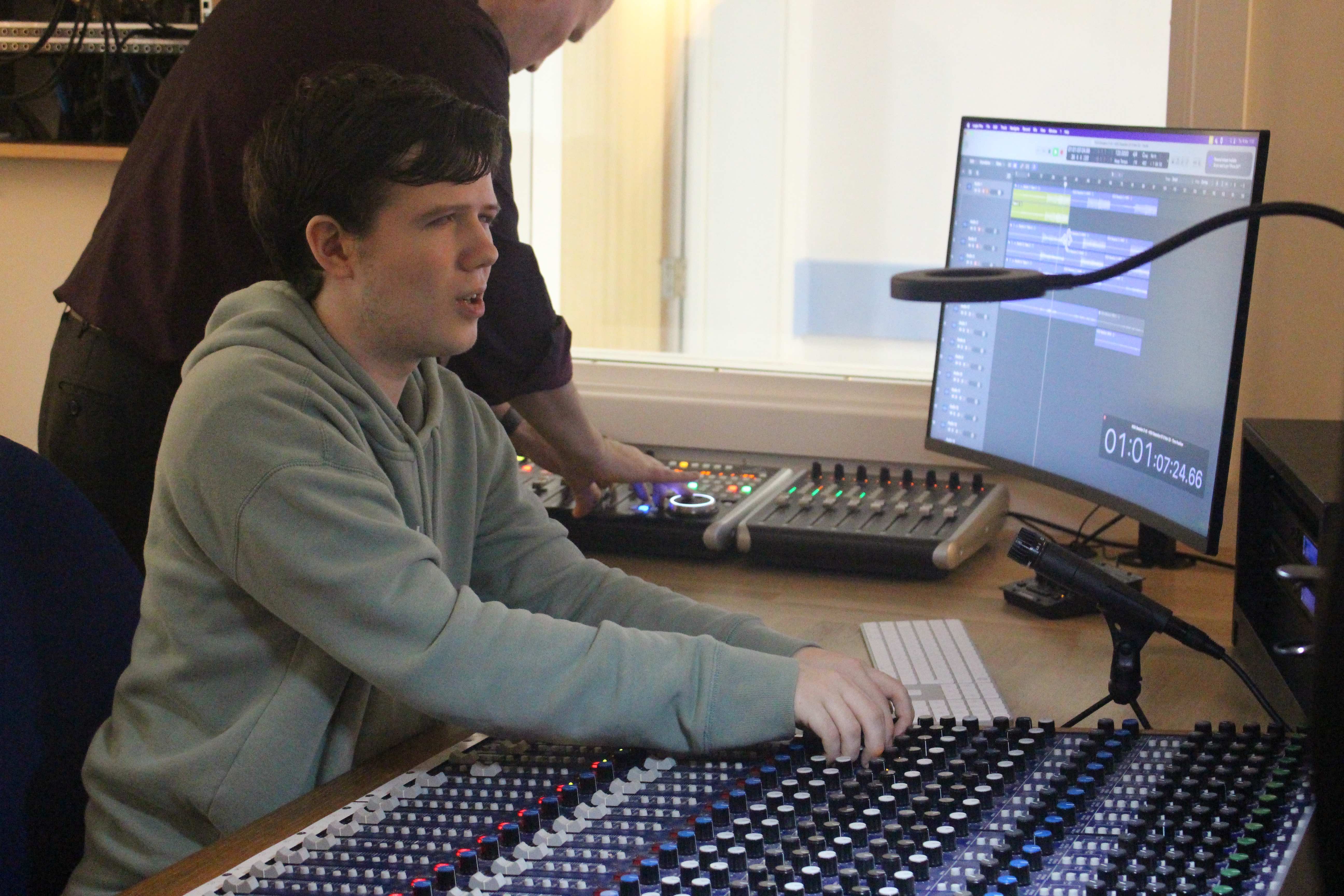 A male student using the mixing desk