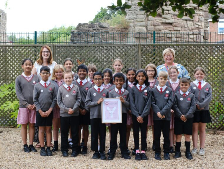 Class 4 with their teacher and RNC's fundraising manager. The class are displaying their Young Leaders certificate