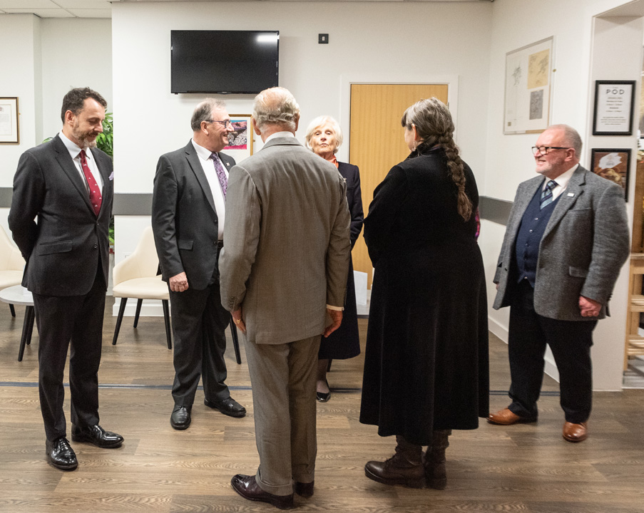 Lucy introducing the King to the governors and President of the College