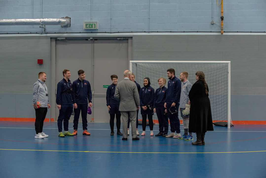 The King talking to the sports staff and students