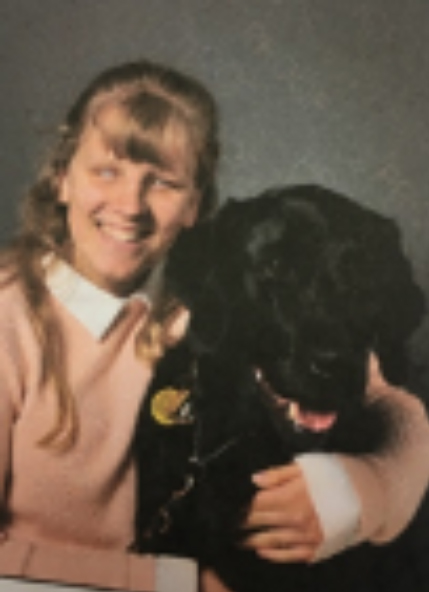 A portrait photo of a smiling Alice with her arm around Billy